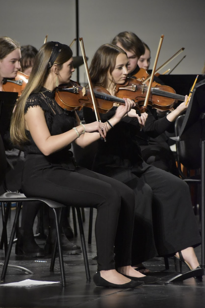 Rachel Beckmeyer (11), Natalie Hoover (11), and Macy Davis (10) perform at winter strings concert.